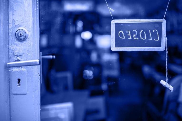 Blue Image of a Shop Door with a Closed Sign on