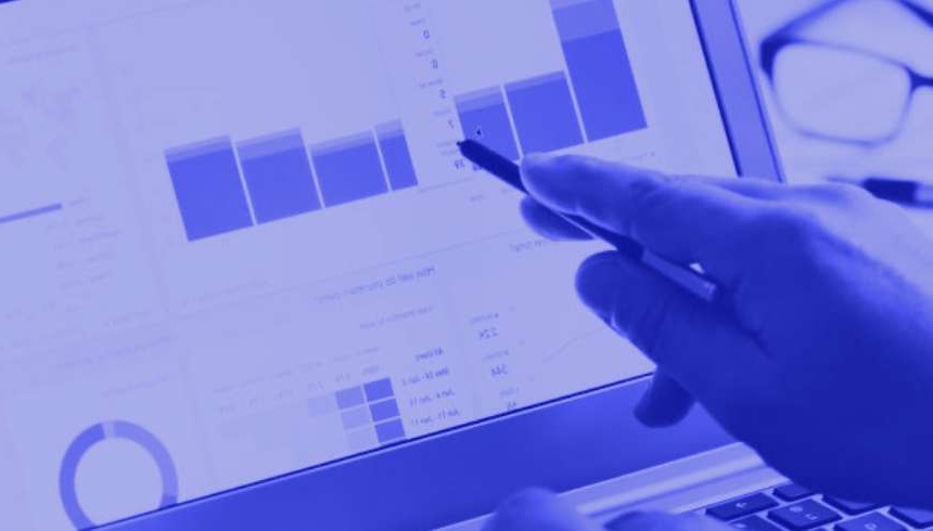Pointing at a screen showing graphical data