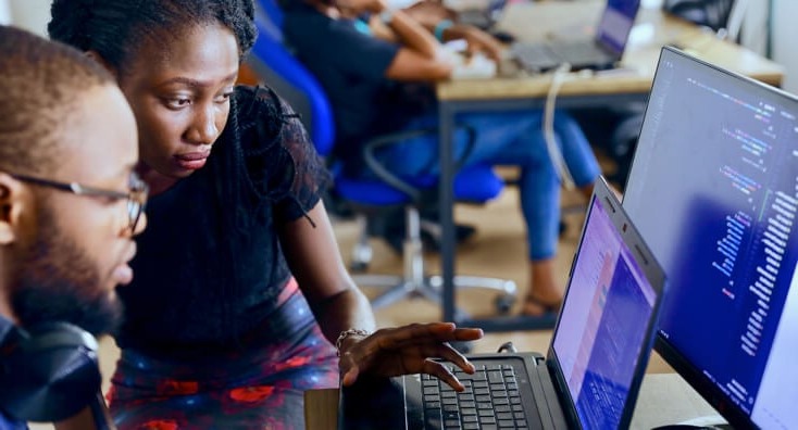 A Man and Woman Working on a Laptop